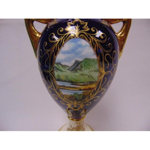 6 - Coalport two handled cobalt blue and cream vase, ornately gilded adn with two panels painted with th... 