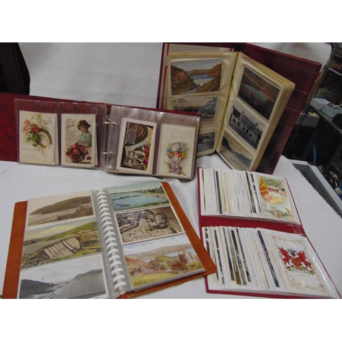 64 - Quantity of vintage postcards in four albums.