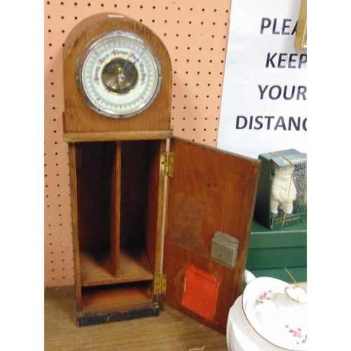 86 - Vintage oak cased barometer cigarete dispenser.