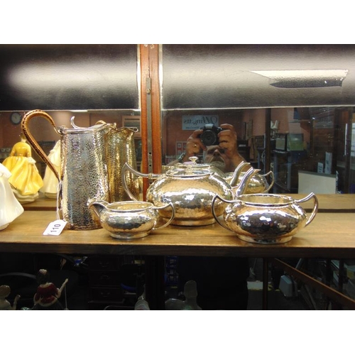 110 - Four piece plated tea service with hammered decoration.