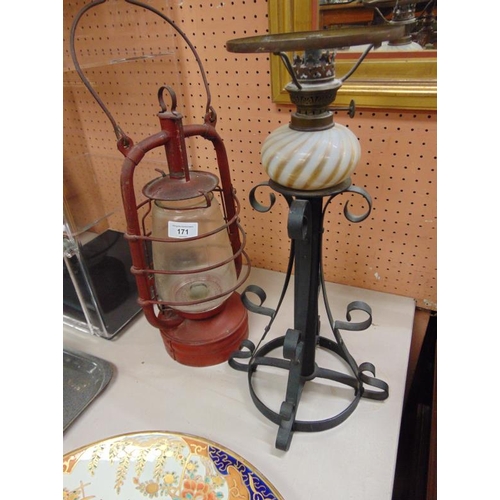 171 - Hurricane lamp and an oil lamp on shaped metal stand (2).