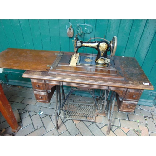 236 - Jones sewing machine, set on treadle base.