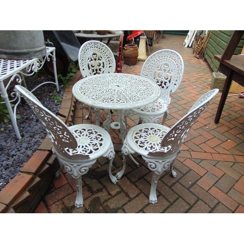 243 - Painted metal garden table and four chairs.