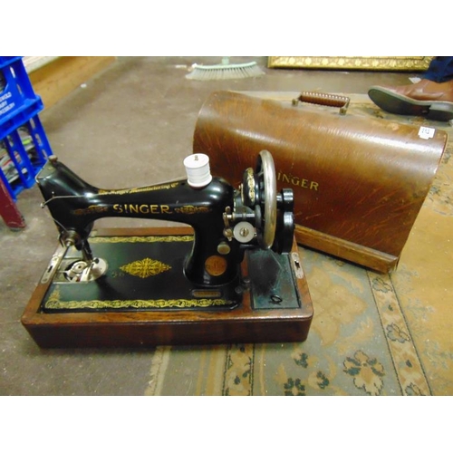 288 - An oak cased singer manual sewing machine.