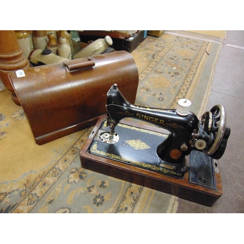 288 - An oak cased singer manual sewing machine.