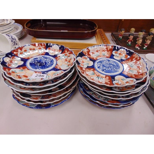 296 - 14 Imari pattern dishes having traditional decoration.