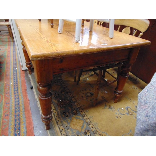 326 - Pitch pine kitchen table, rectangular top, end drawer and on turned supports. 29 x 47 x 35