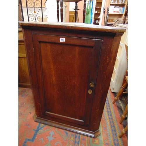 339 - Antique oak corner cupboard, single door and shelf lined interior. 41 x 31