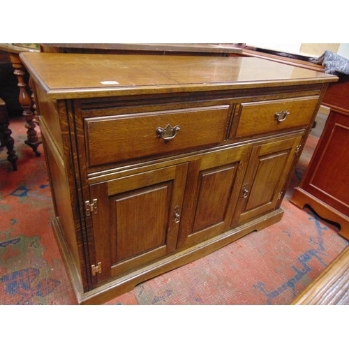 344 - An oak side cabinet, rectangular top, pair of short drawers with metal handles, and two panel doors,... 