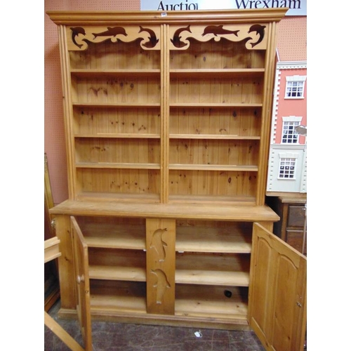 398 - A large modern pine dresser, ogive cornice above dolphin form pierced frieze, shelf lined rack, with... 