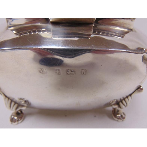 452 - Silver tea caddy of rectangular form, hinged cover with finial and on paw feet. 4.5