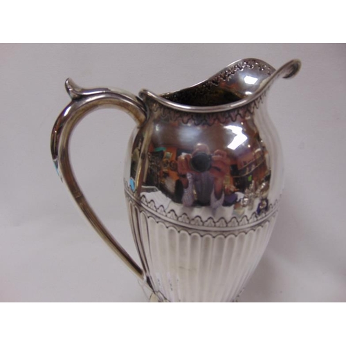 464 - 19th Century silver water jug  having gadrooned body, maker Holland, Son & Slater, London 1882. 19.9... 