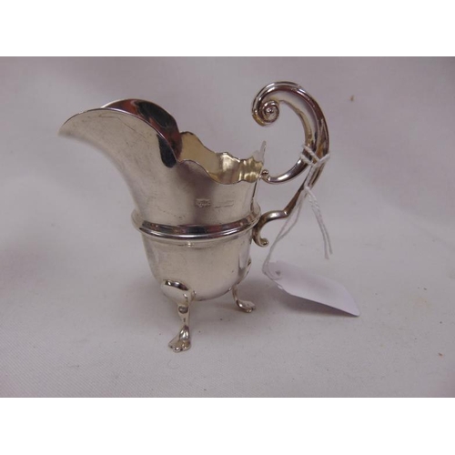 470 - Small silver cream jug, having scroll handle and on pad feet, marks rubbed, 2.5onzs.