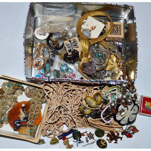 59 - Tin of costume jewellery, pins and badges etc.