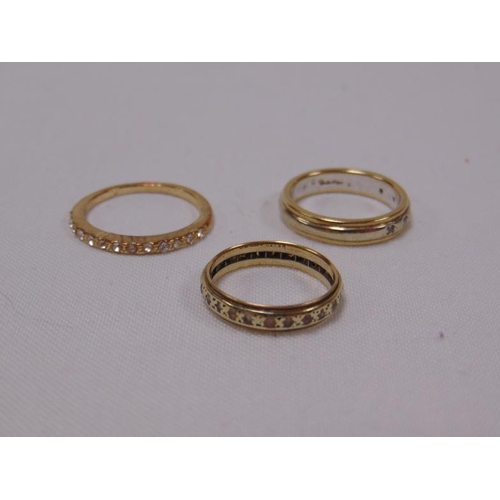 13 - Three possibly gold eternity rings.
