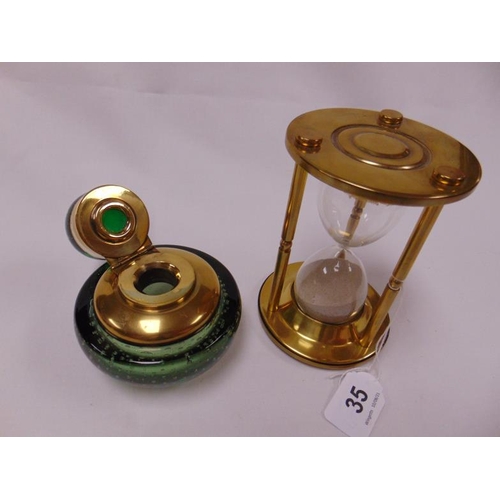 35 - Green glass circular inkwell with brass mounts and a large brass hourglass.