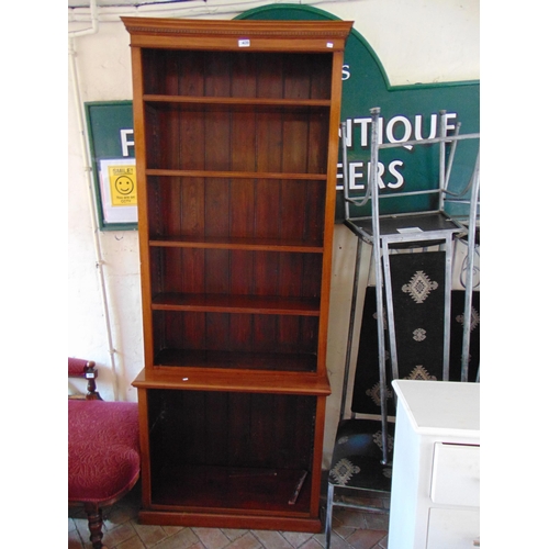 439 - Mahogany bookcase, ogive dentil cornice, above adjustable shelves and on plinth base. 84 x 33 x 13.5... 