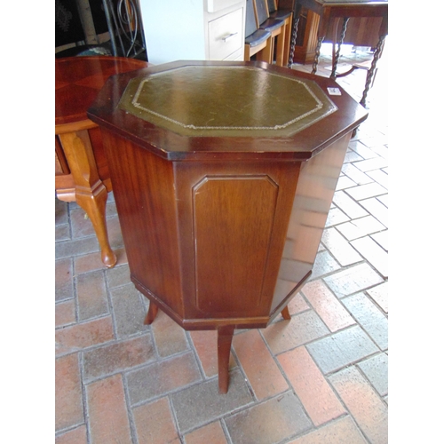 442 - Reproduction octagonal topped cellarette, green leather surface and fitted interior, on splayed supp... 