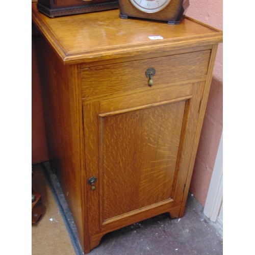 452 - An oak cabinet, dish top, single drawer and cupboard door, on  bracket feet. 33 x 20 x 25