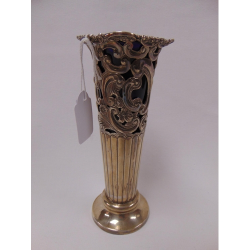 11 - Victorian silver vase with pierced and embossed decoration, with blue glass liner, 7.5