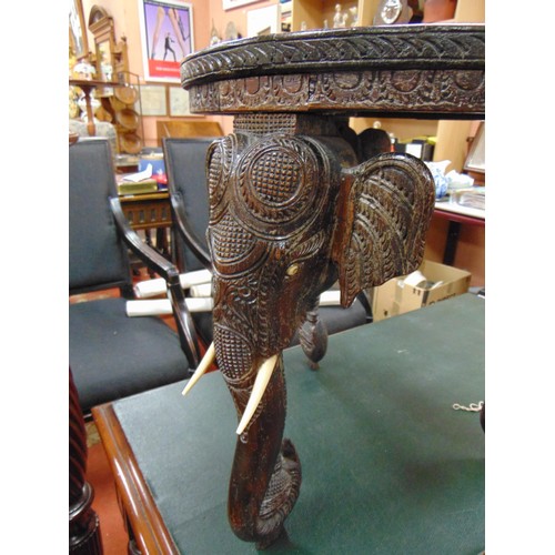 165 - Anglo Indian centre table, heavily carved with elephant head form supports, 19