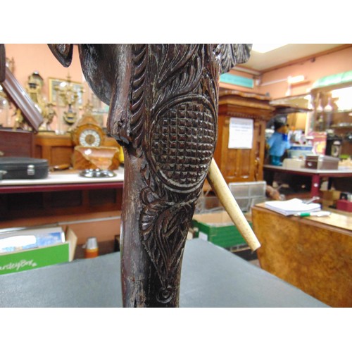 165 - Anglo Indian centre table, heavily carved with elephant head form supports, 19