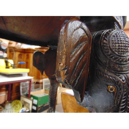 165 - Anglo Indian centre table, heavily carved with elephant head form supports, 19