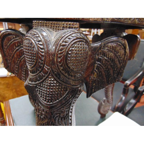 165 - Anglo Indian centre table, heavily carved with elephant head form supports, 19