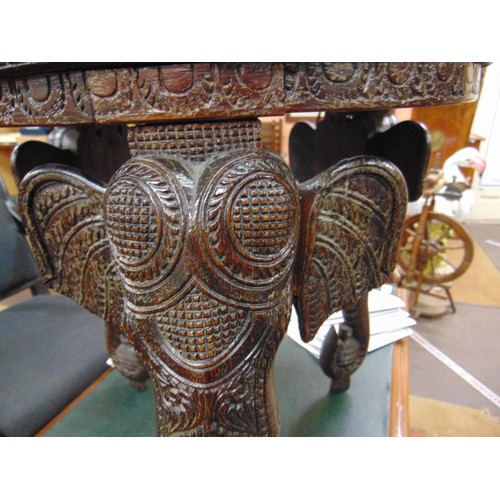 165 - Anglo Indian centre table, heavily carved with elephant head form supports, 19