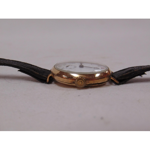 24 - Antique gold plated wristwatch, white enamel dial with Roman numerals and subsidiary seconds dial.