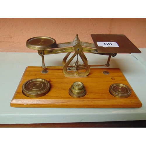 60 - Brass postal scales with weights.