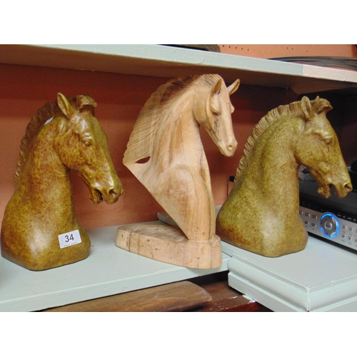 34 - Carved wood horse head and two composite horse heads.