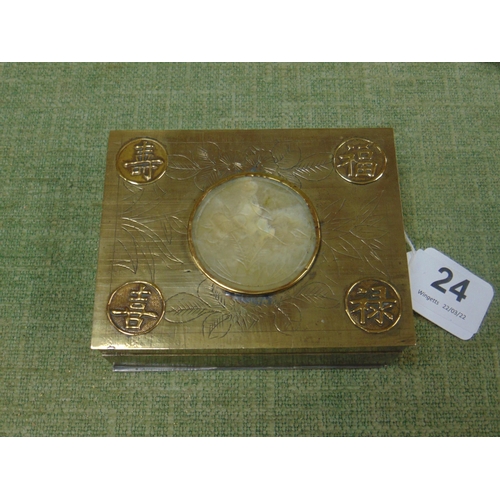 24 - Oriental rectangular brass cigarette box with inset jade roundel to the centre of the cover,