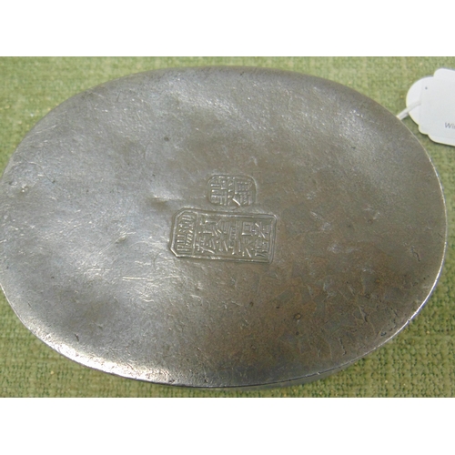 26 - Chinese oval pewter box, the cover with brass rim and pierced brass floral motif to the centre, sign... 