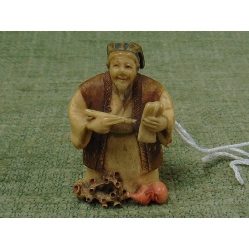 34 - 19th century stained ivory netsuke modelled as a Scribe, signed, 2