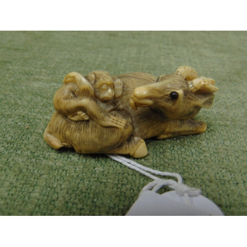 35 - 19th century Chinese ivory netsuke carved as a goat with a monkey on its back, 2.25