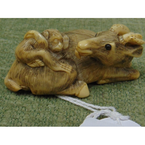 35 - 19th century Chinese ivory netsuke carved as a goat with a monkey on its back, 2.25