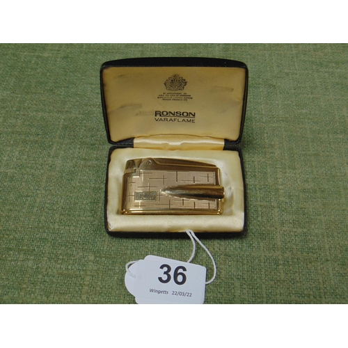 36 - 9ct gold Ronson Varaflame pocket lighter, 71g.
In original box.