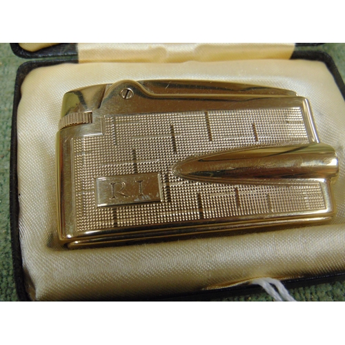 36 - 9ct gold Ronson Varaflame pocket lighter, 71g.
In original box.