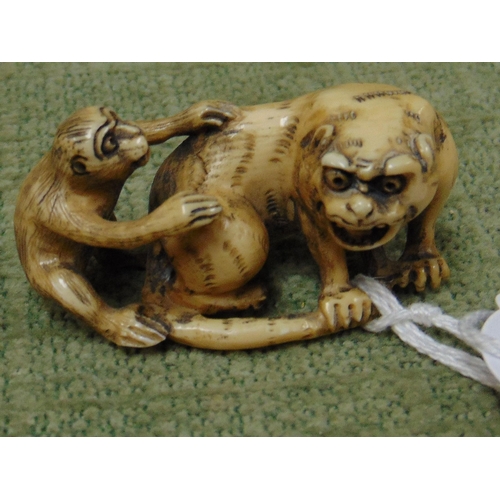 70 - 19th century ivory netsuke, tiger and monkey, signed, 2