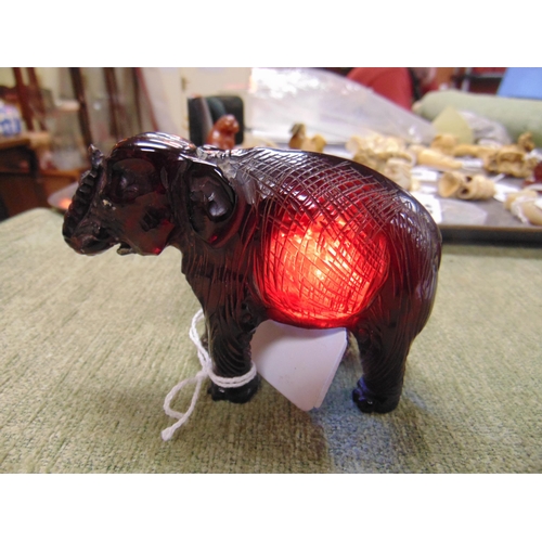 75 - Carved cherry amber figure of an elephant, 3