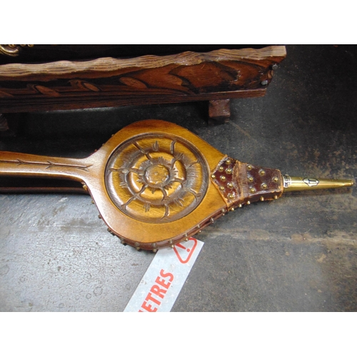 84 - Rustic wooden magazine rack, pair of bellows and an ornate gilt framed wall mirror.