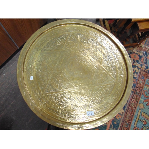 413 - Brass circular occasional table, set on folding base.