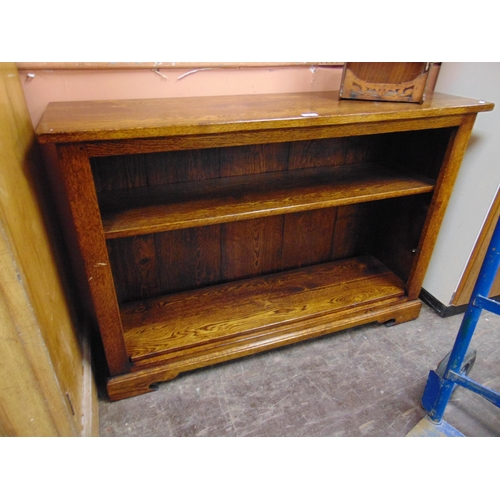 435 - Good reproduction oak bookcase, having pair of adjustable shelves, and on bracket feet. Retailed by ... 