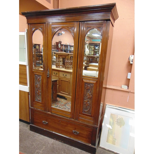 437 - Late 19th century walnut wardrobe, ogive cornice, centre mirror door, flanked by further mirrors wit... 