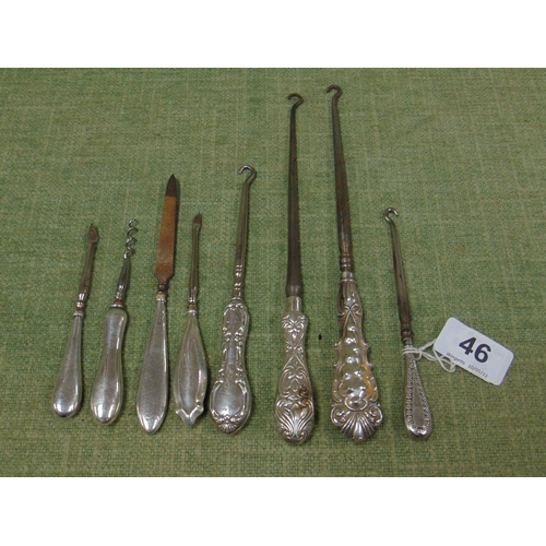 46 - Eight silver handled button hooks, nail file, corkscrew, etc.