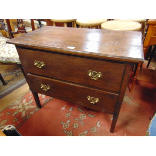 372 - Small oak chest of two short drawers with brass handles and on tapered supports. 28 x 33 x 18