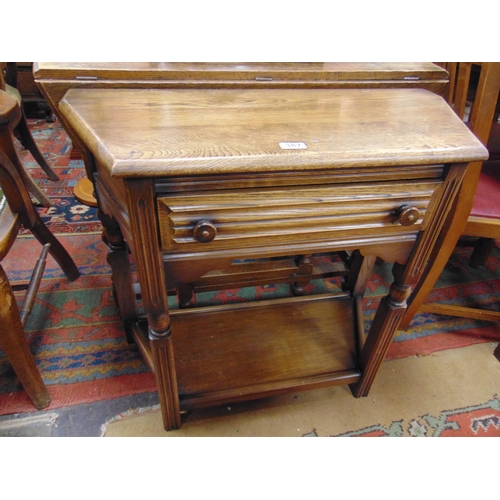 387 - An oak side table, single long drawer with knob handles, fluted supports, joined by an under tier. 2... 