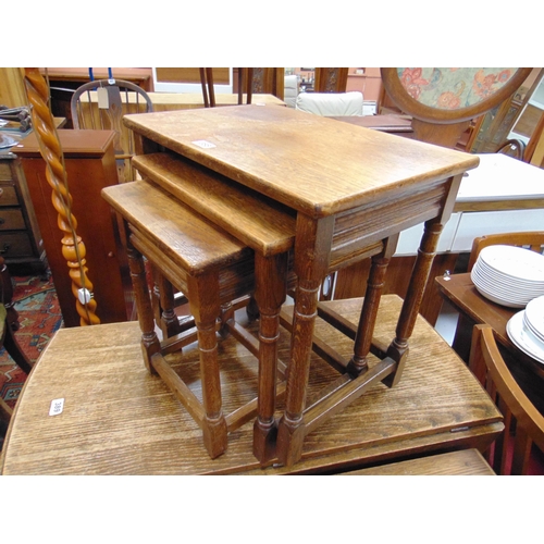 388 - Modern oak nest of three tables, set on turned supports, the tallest 20