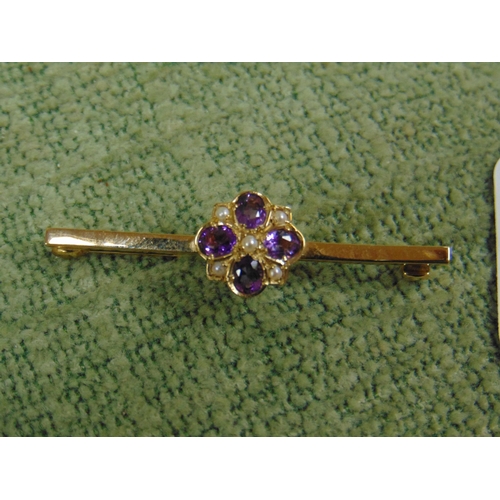 4 - 9ct Gold bar brooch, set with a floral form centre, having Amethyst and seed pearls.